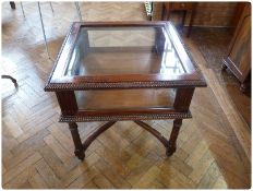 Nineteenth century style square mahogany display table, with bevel glazed top and sides and carved