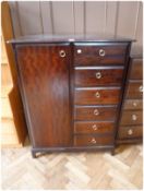 Stag Furniture chest with cupboard for hanging space, flanked by six drawers on bracket feet