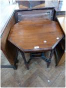 Edwardian mahogany octagonal top side table, on ring turned supports, with galleried shelf below,