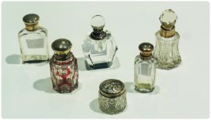 A small collection of five silver mounted glass scent bottles, various, together with a circular