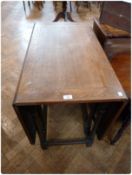 A 20th century oak dropflap dining table, on turned legs united by stretchers, 92cm wide