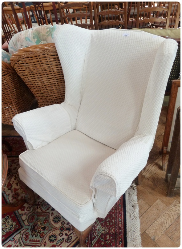 A pair wing armchairs, with ivory coloured loose colours, cushion seats, on cabriole legs