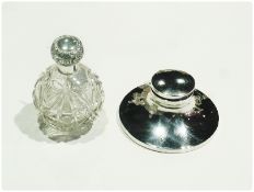 A George V silver capstan-shaped inkwell, with hinged cover on spreading circular base, Birmingham