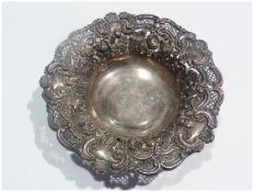 A Victorian silver circular dish, with foliate and C-scroll pierced border, raised on a circular