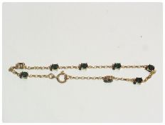 9ct gold and green coloured stone link bracelet and pair gold coloured metal and green three stone