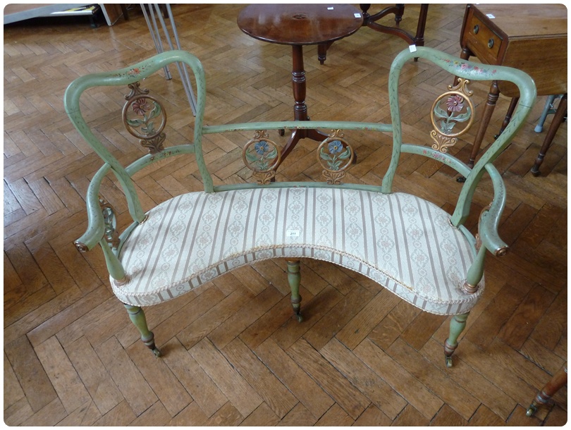 Edwardian kidney-shaped polychrome love seat, with carved floral splats, upholstered seat, on