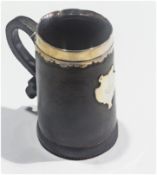 A late 19th/early 20th century leather quart mug, with sterling silver rim, and armorial shield,