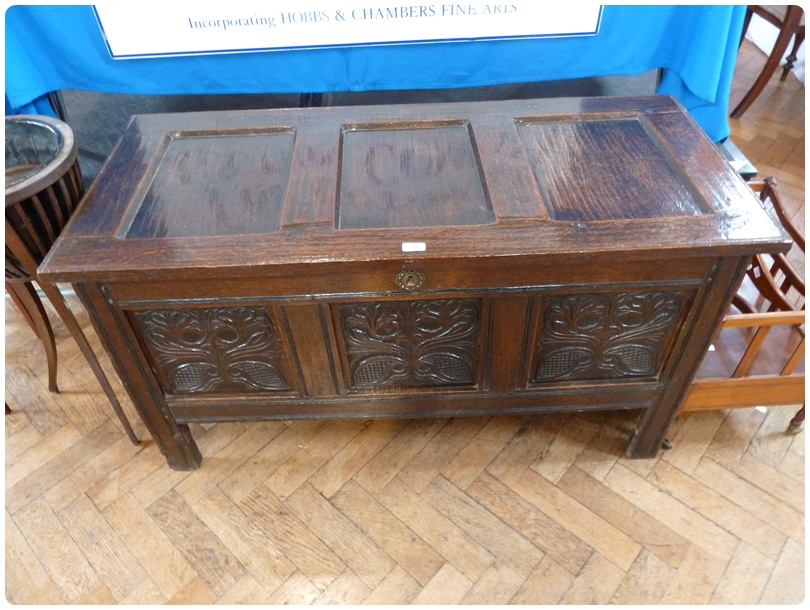 Early eighteenth century oak coffer, with three panel top, foliate carved panel front, fitted with