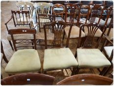 Two Georgian mahogany dining chairs, with pierced splat back, upholstered stuff-over seats, on