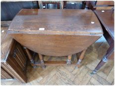 Reproduction oak oval top gate-leg table, on turned legs united by stretchers, width 76cm