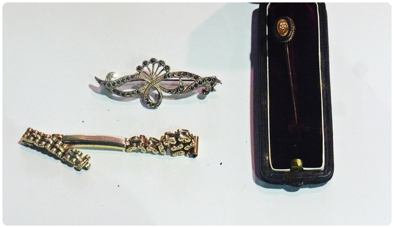 Enamelled stickpin in fitted case, stud box containing spare watch bracelet links and a marcasite