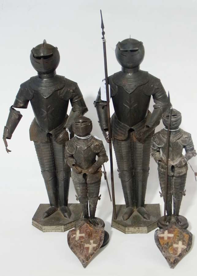 Two tin-type metal model knights, with painted metal shields and two similar larger metal model