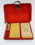 Set of "Tsung Chung Chong Ivory Co." mahjong set with simulated ivory pieces in leather carrying