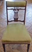 An Edwardian inlaid mahogany sewing chair with lyre pierced splatback, stuffover seat and padded
