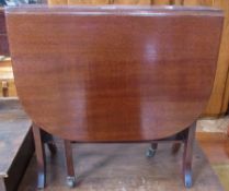 An Edwardian mahogany drop flap Sutherland table, with open slatted sides, shelf below on square