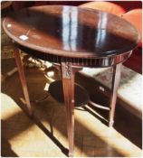 An Edwardian mahogany oval occasional table, with moulded edge top, and fluted frieze, on square