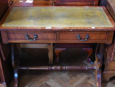A reproduction mahogany sofa table, with inset leather top, two frieze drawers and two dummy drawers