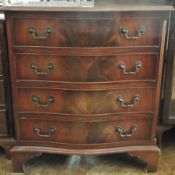 A reproduction mahogany serpentine front chest of drawers with moulded edge top, four long graduated