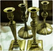 A pair of nineteenth century brass candlesticks of tapering form on raised square bases, together