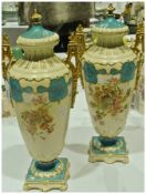 Pair of Rudolstadt lidded vases,  ovoid and tapering to square base, floral decorated, gilt rim on