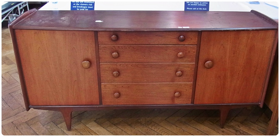 Circa 1960's sideboard, with four central graduated drawers flanked by cupboards, raised on tapering