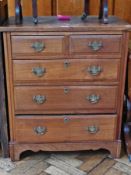 An early twentieth century walnut chest of two short and three long graduated drawers raised on