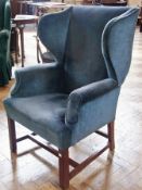 20th century blue upholstered wingback armchair, on straight supports