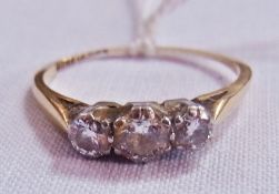 Gold and three-stone diamond ring