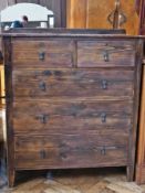 Twentieth century stained pine chest of two short and three long graduated drawers raised on