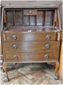 A reproduction mahogany bureau with fall-front enclosing pigeonholes and single drawer, with three