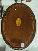 An Edwardian mahogany oval tray, with satinwood patera inlay, and brass carrying handles, together