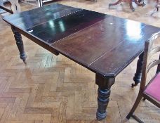 A Victorian stained oak wind-out dining table, with extra leaf, on ring turned tapering legs with