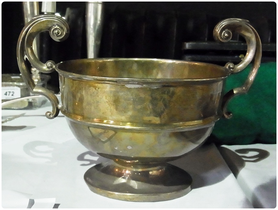 George V silver two-handled trophy cup, of plain form, with scroll handles, raised on circular foot,