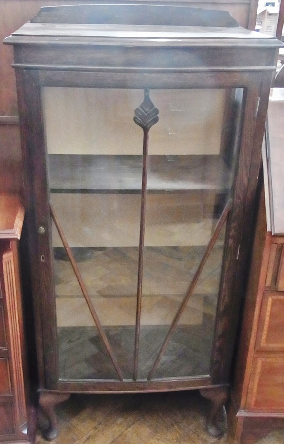 A twentieth century stained oak glazed china cabinet, with three shelves raised on short cabriole