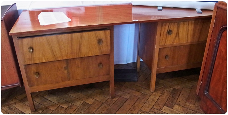 Late 20th century walnut kneehole dressing table, with two deep drawers to either side, raised on