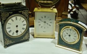 An old black lacquer mantel clock with enamel dial, a German quartz movement carriage clock and a