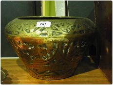 An Eastern beaten brass jardiniere, animal design, dia. 30cms, together with two Eastern copper