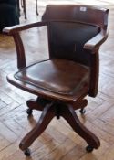 Early 20th century oak swivel office chair, on quadruped base