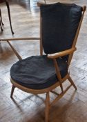 Ercol light armchair with blue cushions