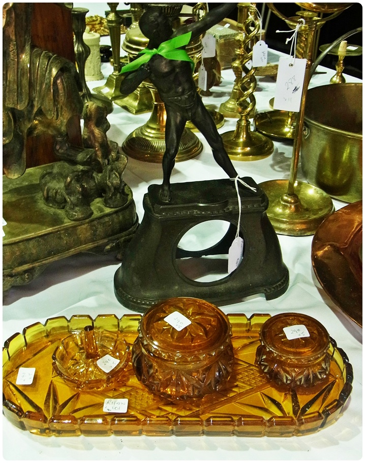 A Spelter figure of an archer, mounted on a clock case, height 35cm, together with an amber glass