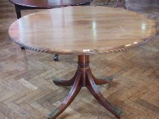 A Georgian style mahogany circular topped supper table, with crossbanded and reeded border, raised