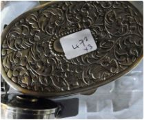 White metal oval box, with hinged cover and foliate scrollwork design, a white metal circular pill