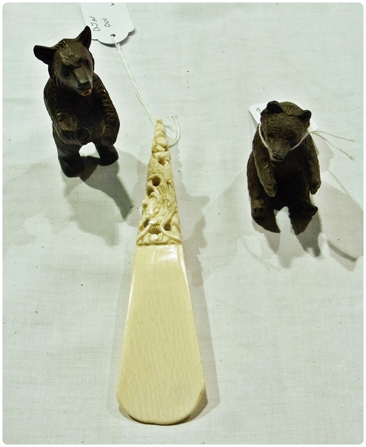 Two carved wooden Bavarian bears, together with a carved ivory shoe horn