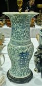 Chinese porcelain blue and white waisted lamp base, floral decorated with symbols, on a wooden base,