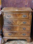 A reproduction mahogany bachelor's chest, with foldover top, four graduated drawers, on bracket