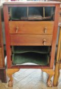 An Edwardian mahogany music cabinet with fall front drawers, raised on cabriole legs with claw and
