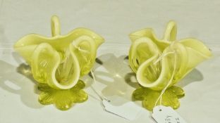 Pair of yellow opaline handkerchief style vases, with inverted rims and handles, on wavy shaped