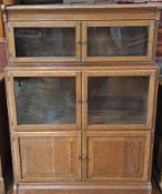 An early twentieth century glazed oak bookcase, with two glazed cupboards, and fielded cupboard