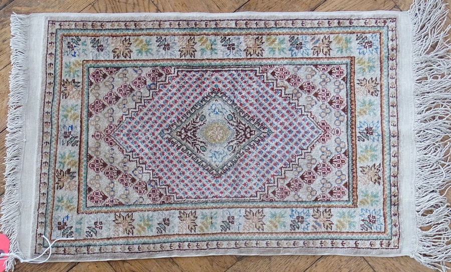 Persian style silk mat, with central diamond and floral borders, 39 x 60cm