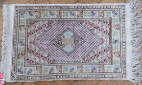 Persian style silk mat, with central diamond and floral borders, 39 x 60cm